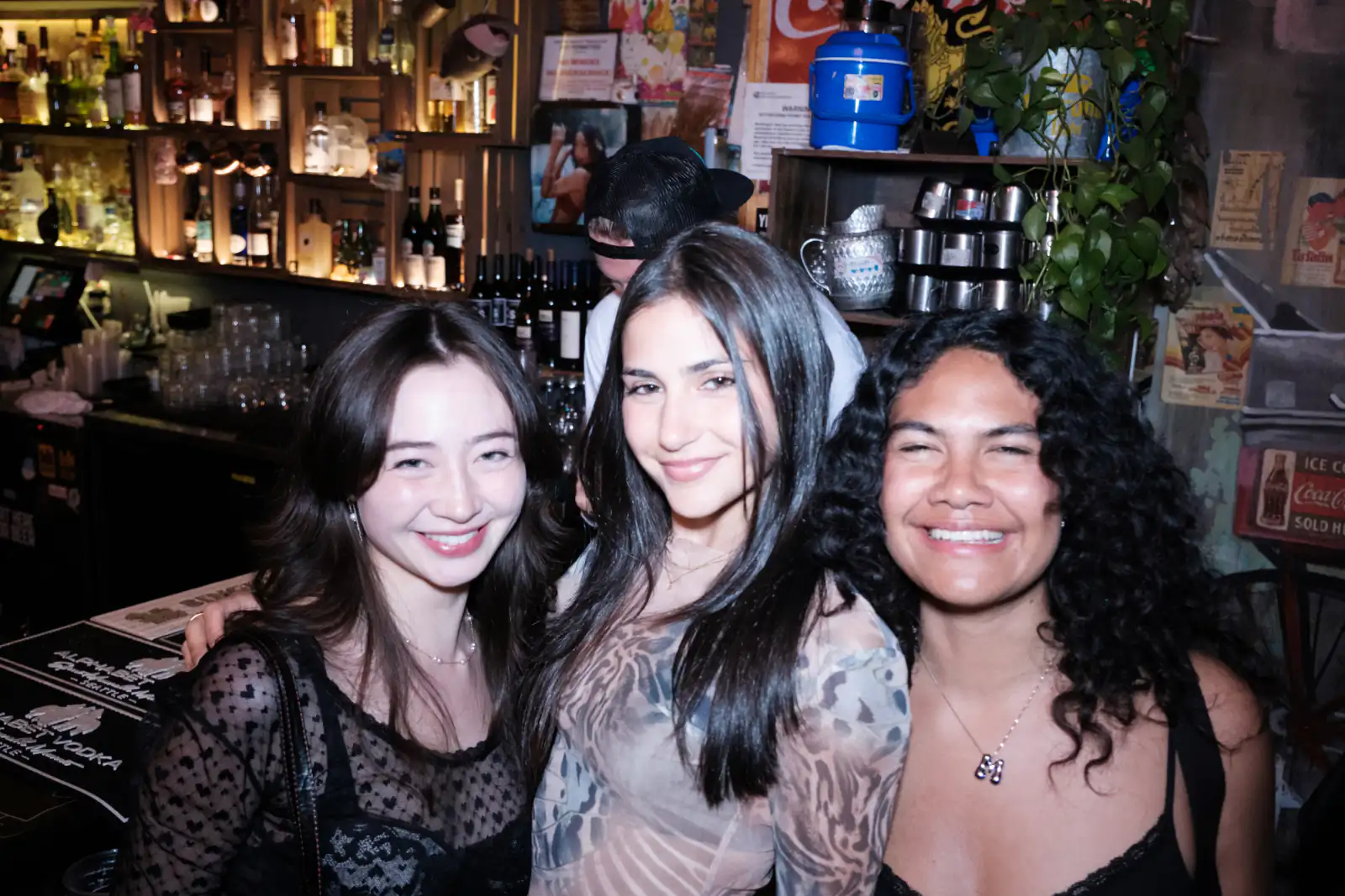 People posing for a picture in a bar